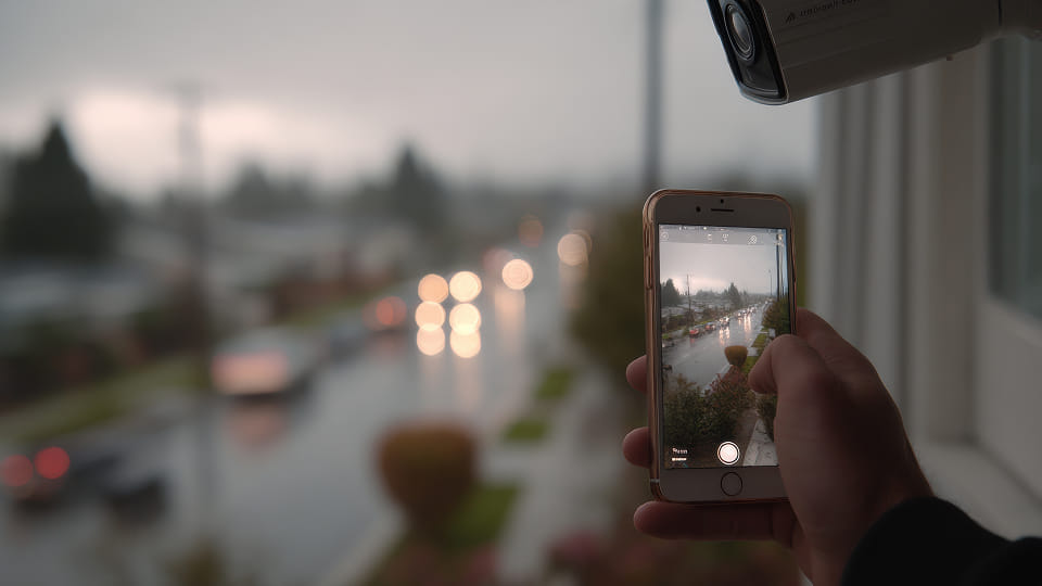 A person taking a picture of a street with a camera