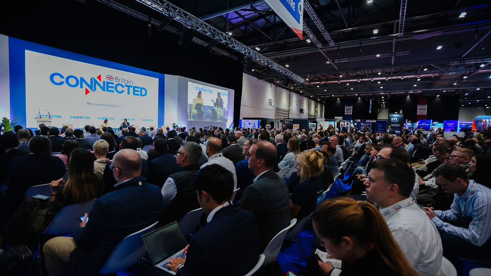 udience attending Britain Connected conference session at a large technology exhibition hall.