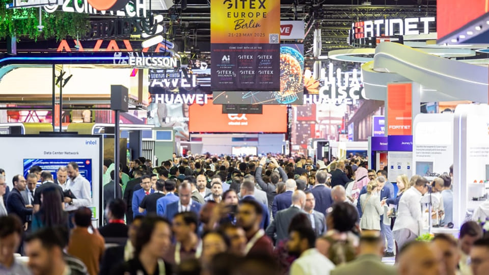 Crowds of attendees exploring technology booths at GITEX Global Event